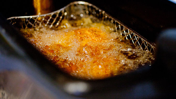 Chicken dipped in fryer basket